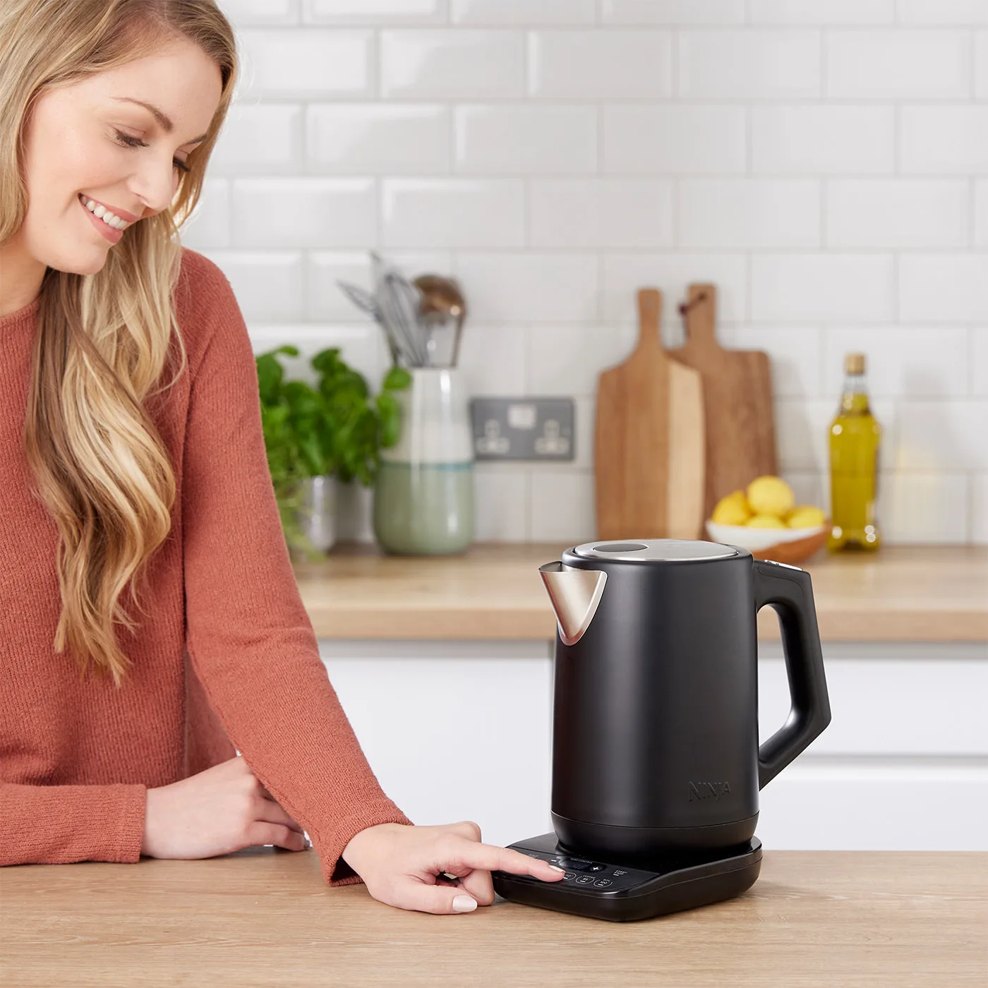 Ninja-KT200UK-Black_Kettle-InUse-Pressing_UI-Woman-Wide-6